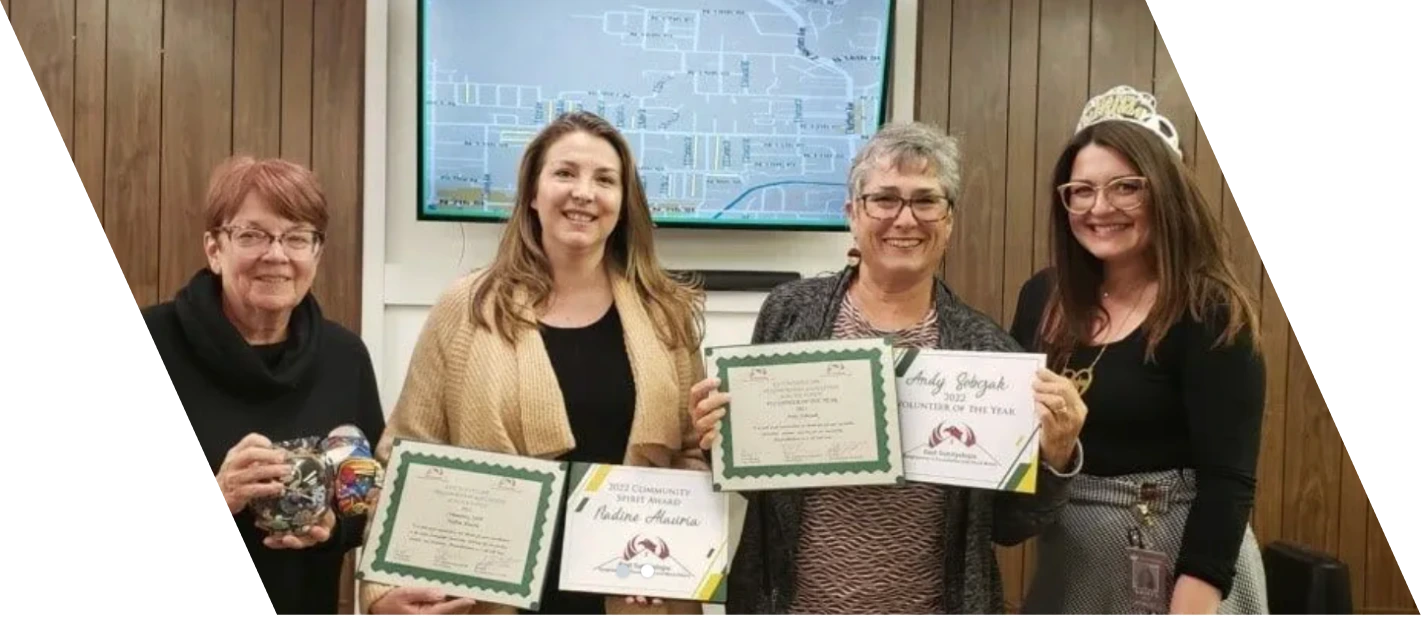 Nadine Alauria receiving the 2022 Community Spirit Award from East Sunnyslope Neighborhood Association representatives including Jeff Tisot, Councilwoman Debra Stark, and other community leaders