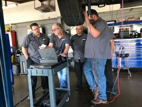 Eric Ziegler conducting advanced automotive diagnostics training at 3A Automotive shop in 2019