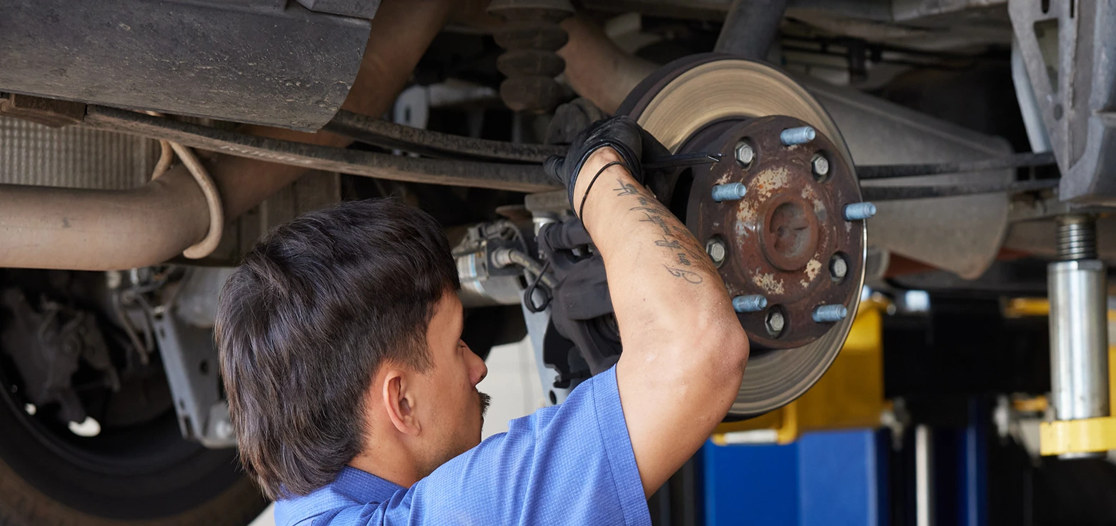 Professional mechanic performing oil change service