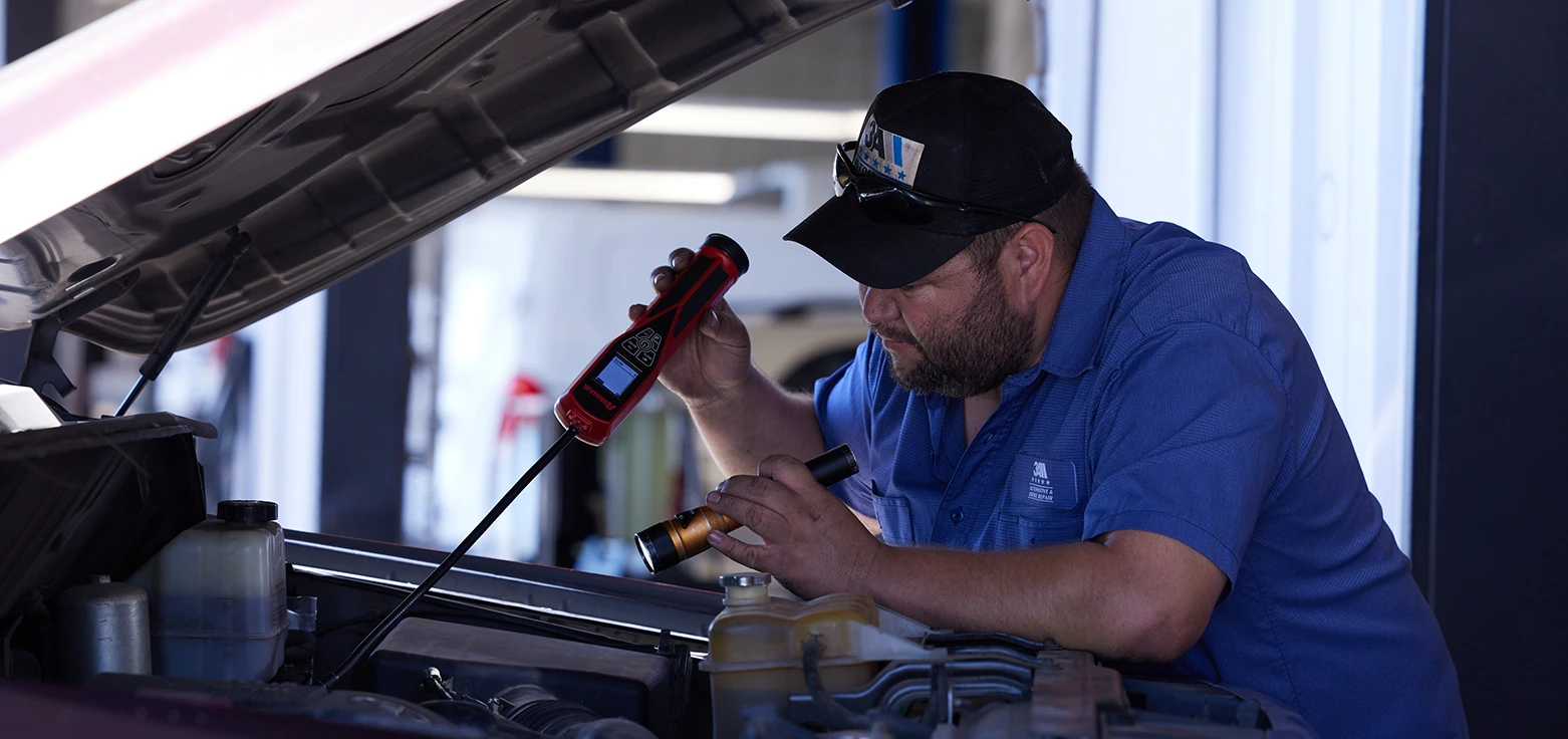 Professional mechanic performing oil change service