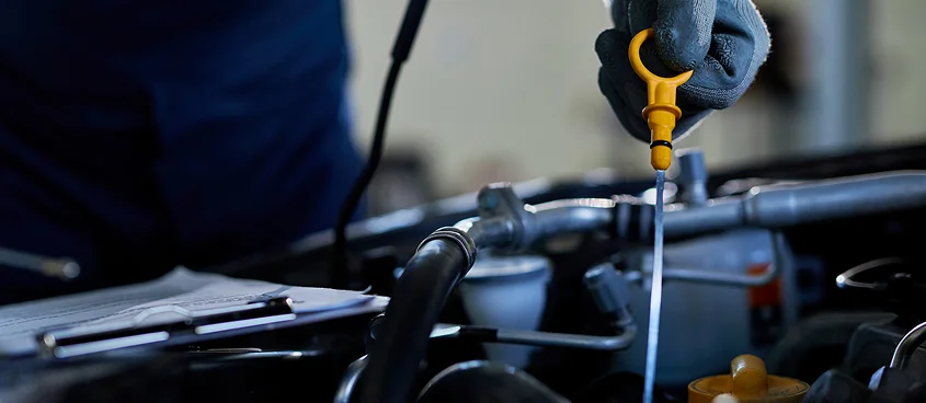 Professional mechanic performing oil change service